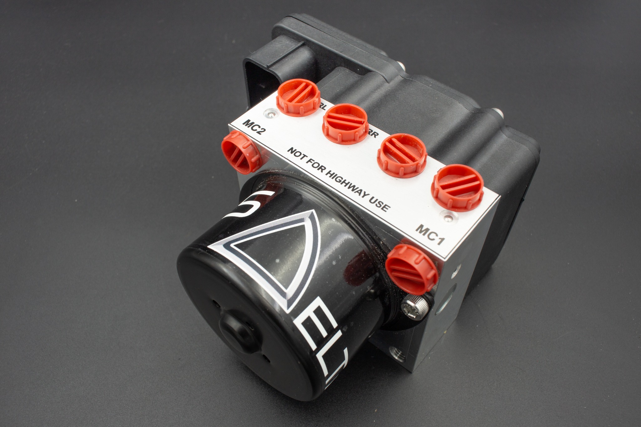 Delta ABS hydraulic modulator with capped and labelled brake line ports